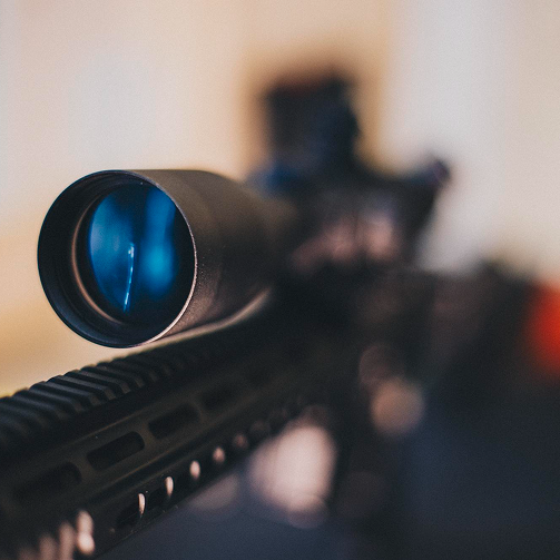 Close-up of a rifle scope and rail accessories